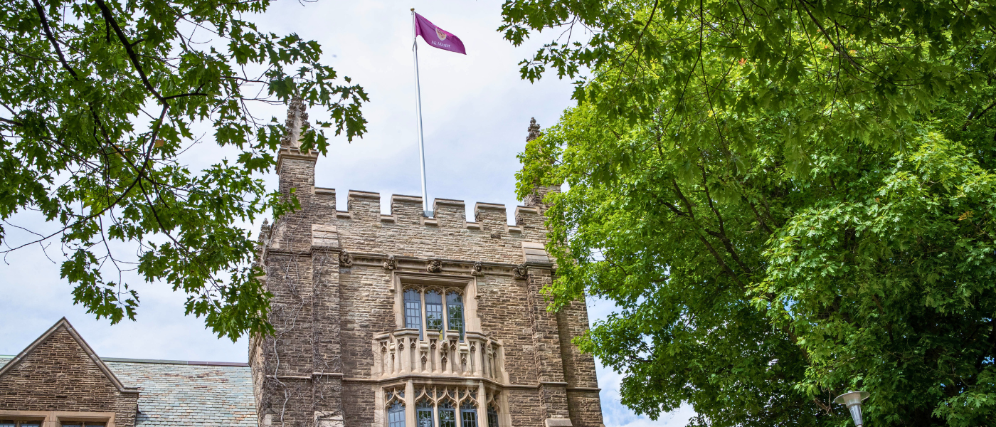 Wide shot of University Hall flag in summer.